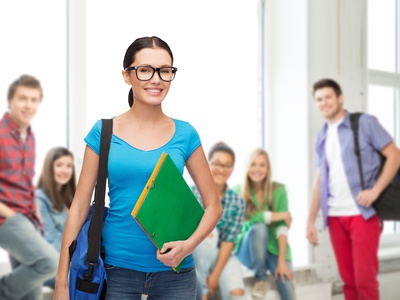 education and people concept - smiling student in eyeglasses with bag and folders standing